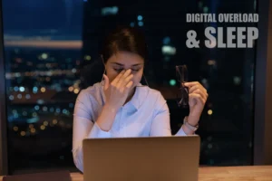 Woman rubbing her eyes from digital fatigue late at night in front of a laptop, illustrating how information overload affects sleep quality